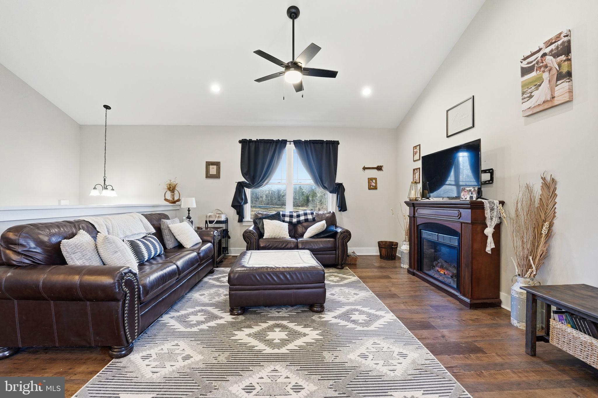 11183 Drogheda Mountain Road Culpeper, VA 22701 - Photo 24 of 60 a living room with furniture and a flat screen tv