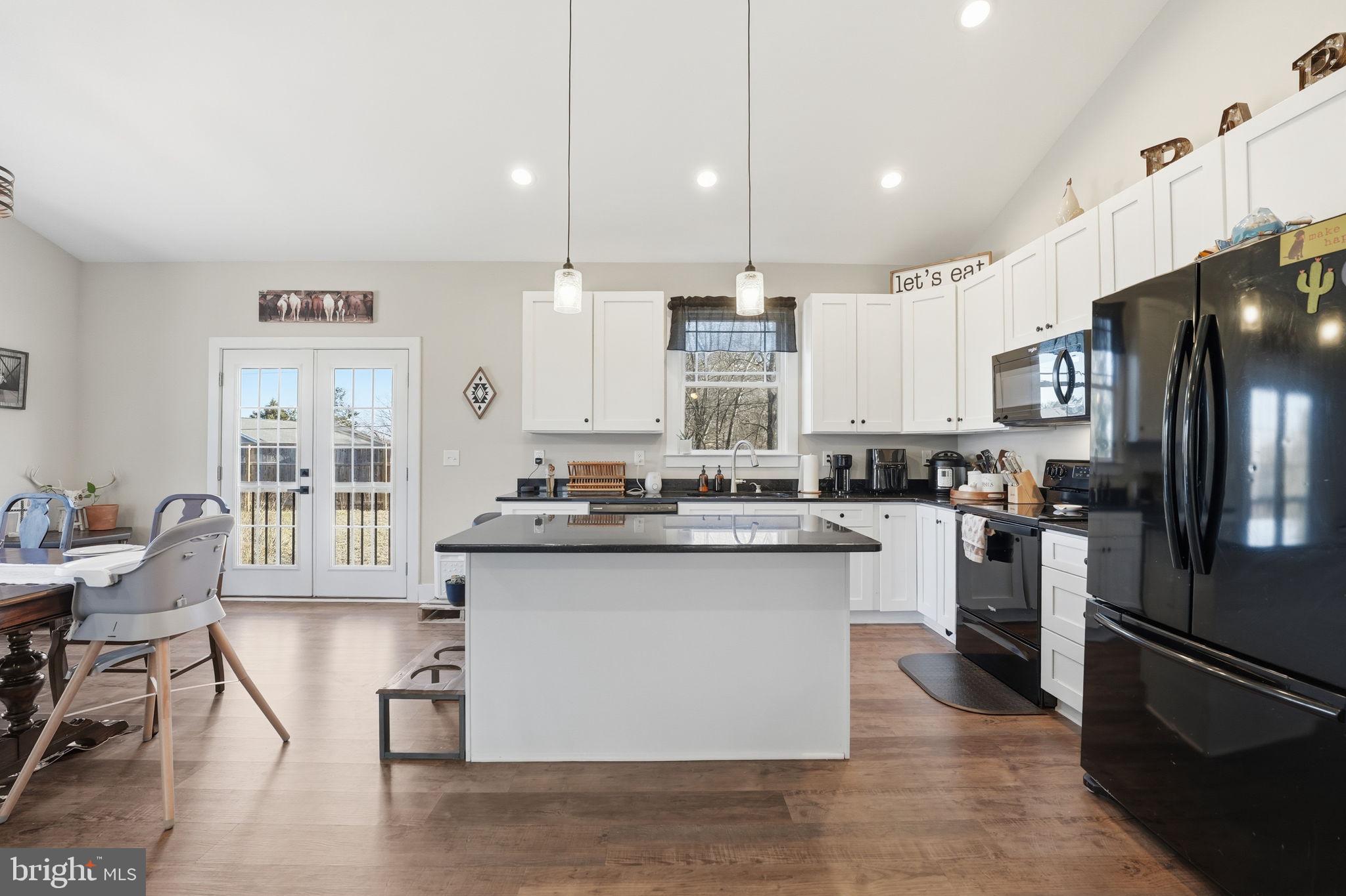 11183 Drogheda Mountain Road Culpeper, VA 22701 - Photo 10 of 60 a kitchen with stainless steel appliances granite countertop a stove top oven a refrigerator a sink and a chairs