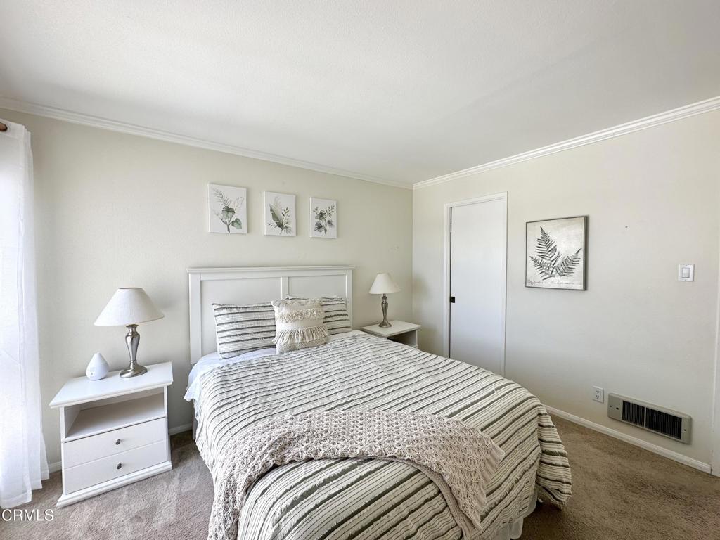 2901 Peninsula Road, Unit 347 Oxnard, CA 93035 - Photo 11 of 13 a bedroom with a bed and a lamp