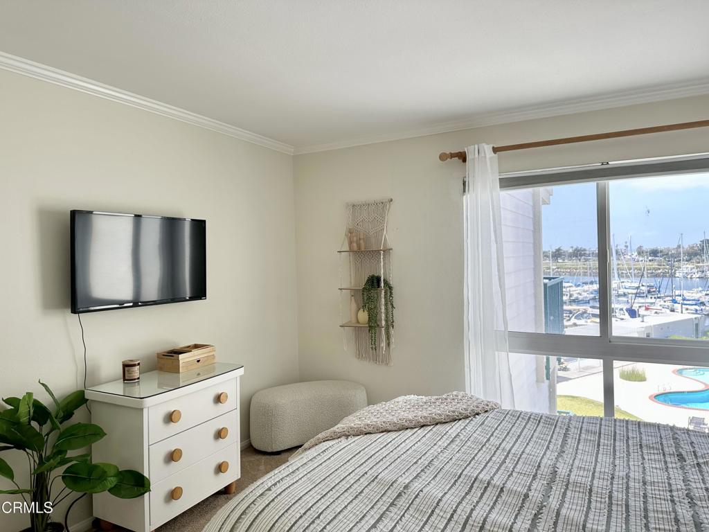 2901 Peninsula Road, Unit 347 Oxnard, CA 93035 - Photo 12 of 13 a bedroom with a bed and a flat tv screen on the dresser