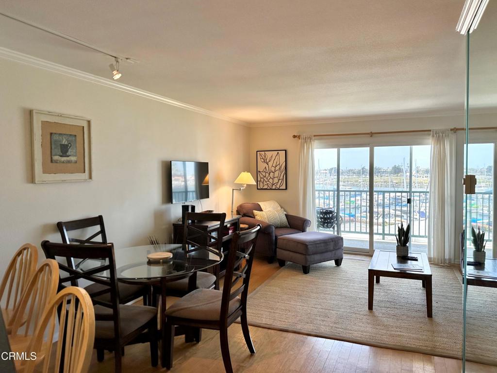 2901 Peninsula Road, Unit 347 Oxnard, CA 93035 - Photo 4 of 13 a living room with furniture and a floor to ceiling window