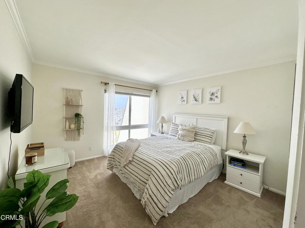 2901 Peninsula Road, Unit 347 Oxnard, CA 93035 - Photo 10 of 13 a bedroom with a bed a flat screen tv and dresser