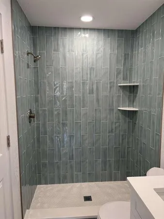 a bathroom with a shower and a sink