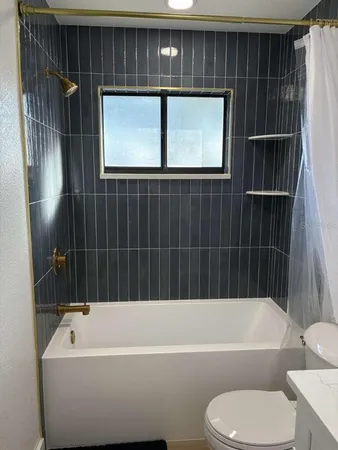 a bathroom with a bathtub and a toilet