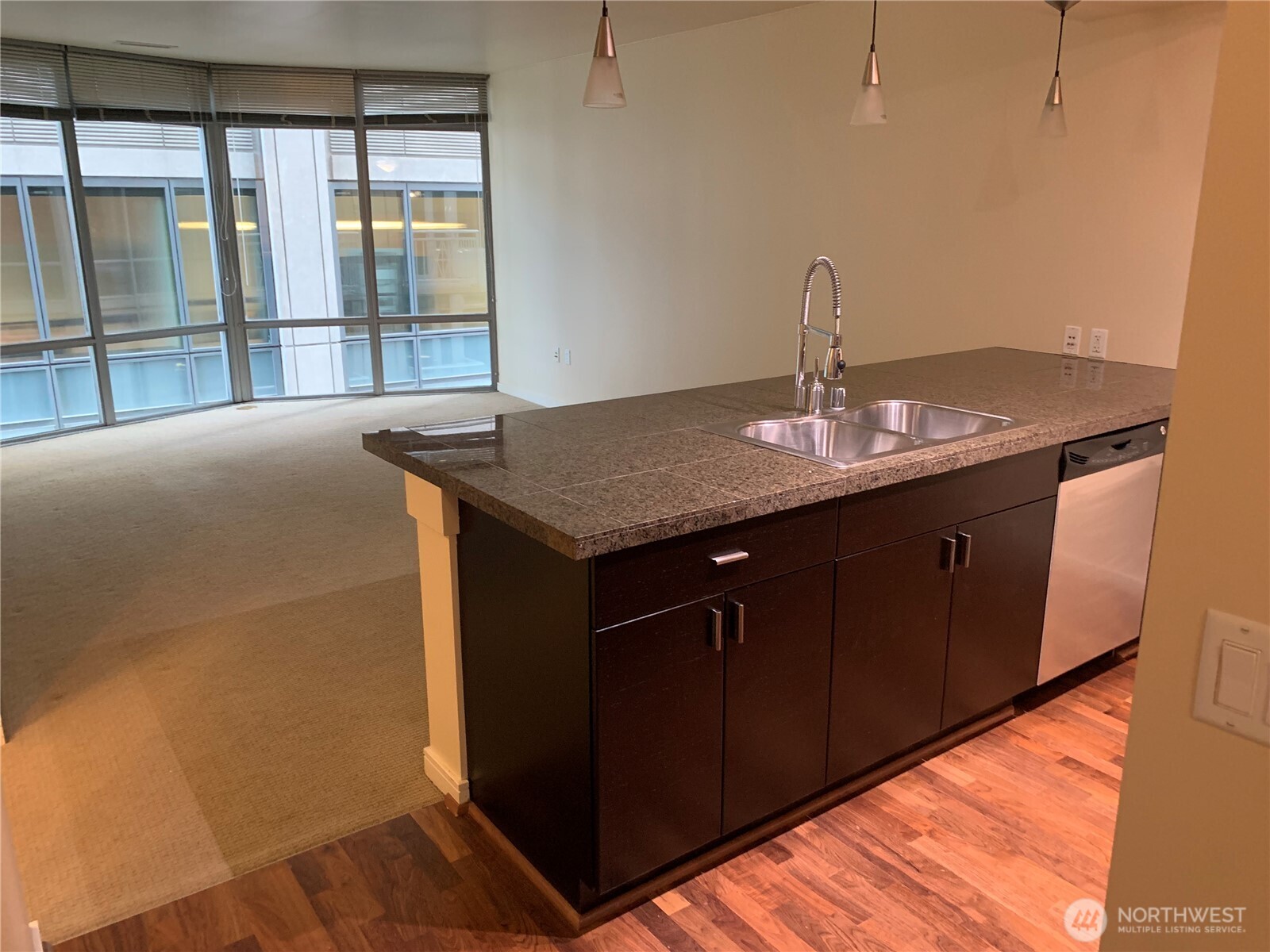 819 Virginia Street, Unit 2808 Seattle, WA 98101 - Photo 12 of 34 a kitchen with a sink a counter top space and a large window