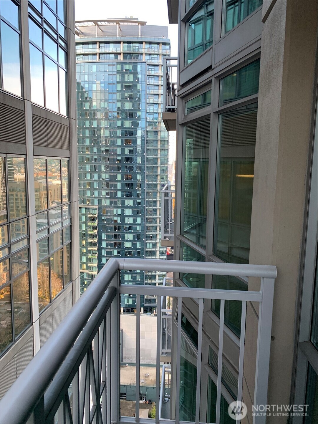 819 Virginia Street, Unit 2808 Seattle, WA 98101 - Photo 17 of 34 a view of a balcony with a large window and wooden floor