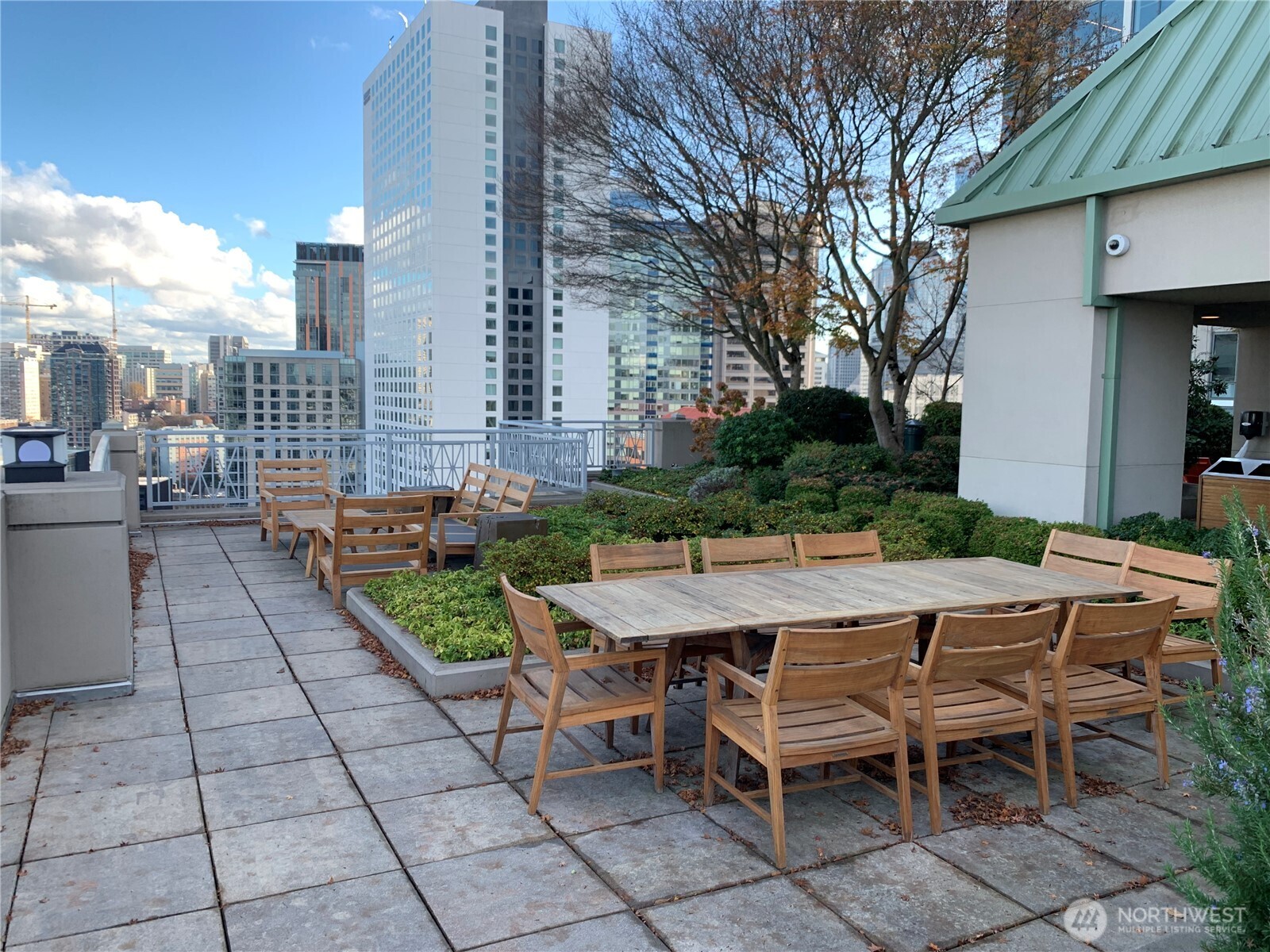 819 Virginia Street, Unit 2808 Seattle, WA 98101 - Photo 31 of 34 a view of a patio with table and chairs and potted plants