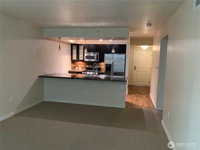 a kitchen with granite countertop a stove and a microwave