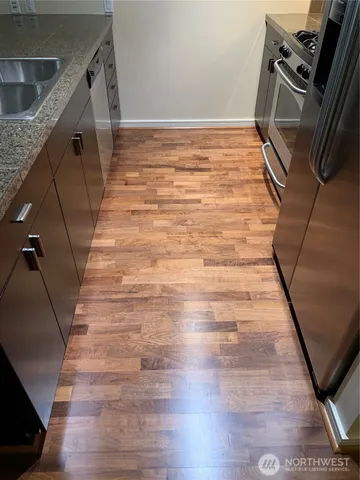 a kitchen with a sink a counter top space and a large window