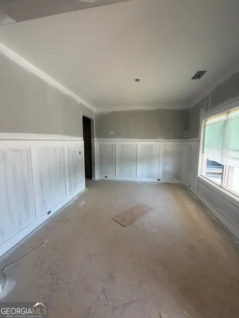 an empty room with a empty space and windows