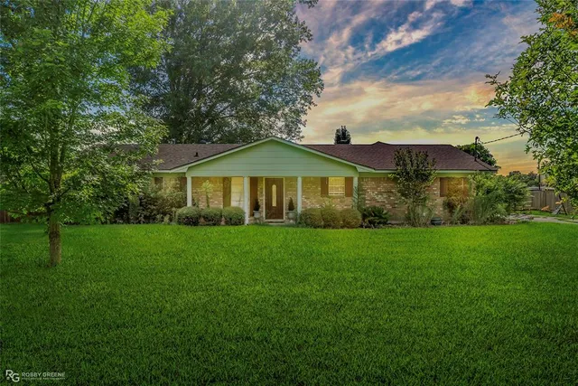 a view of a house with yard and green space