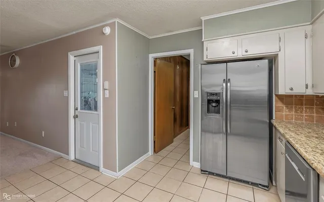 a kitchen with granite countertop cabinets stainless steel appliances and a sink