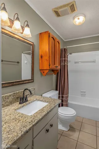 an empty room with windows and chandelier fan