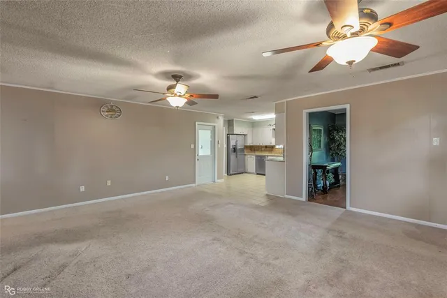 en view interior of a house with a ceiling fan and a chandelier fan