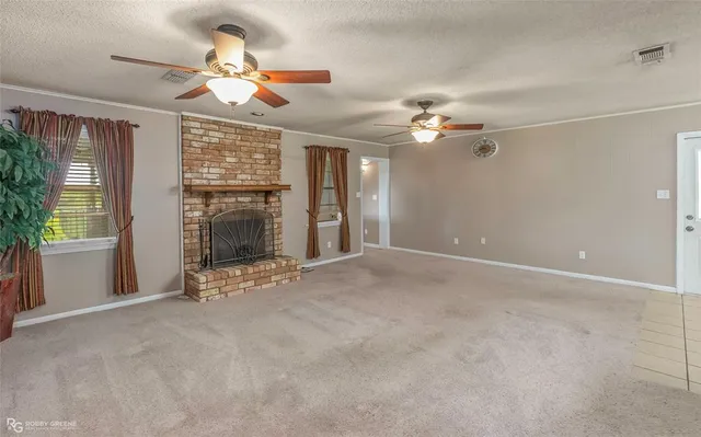 a view of a livingroom with a ceiling fan and window