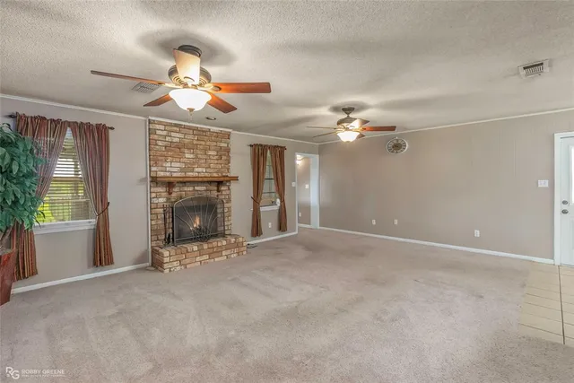 a view of a livingroom with a fireplace and fan