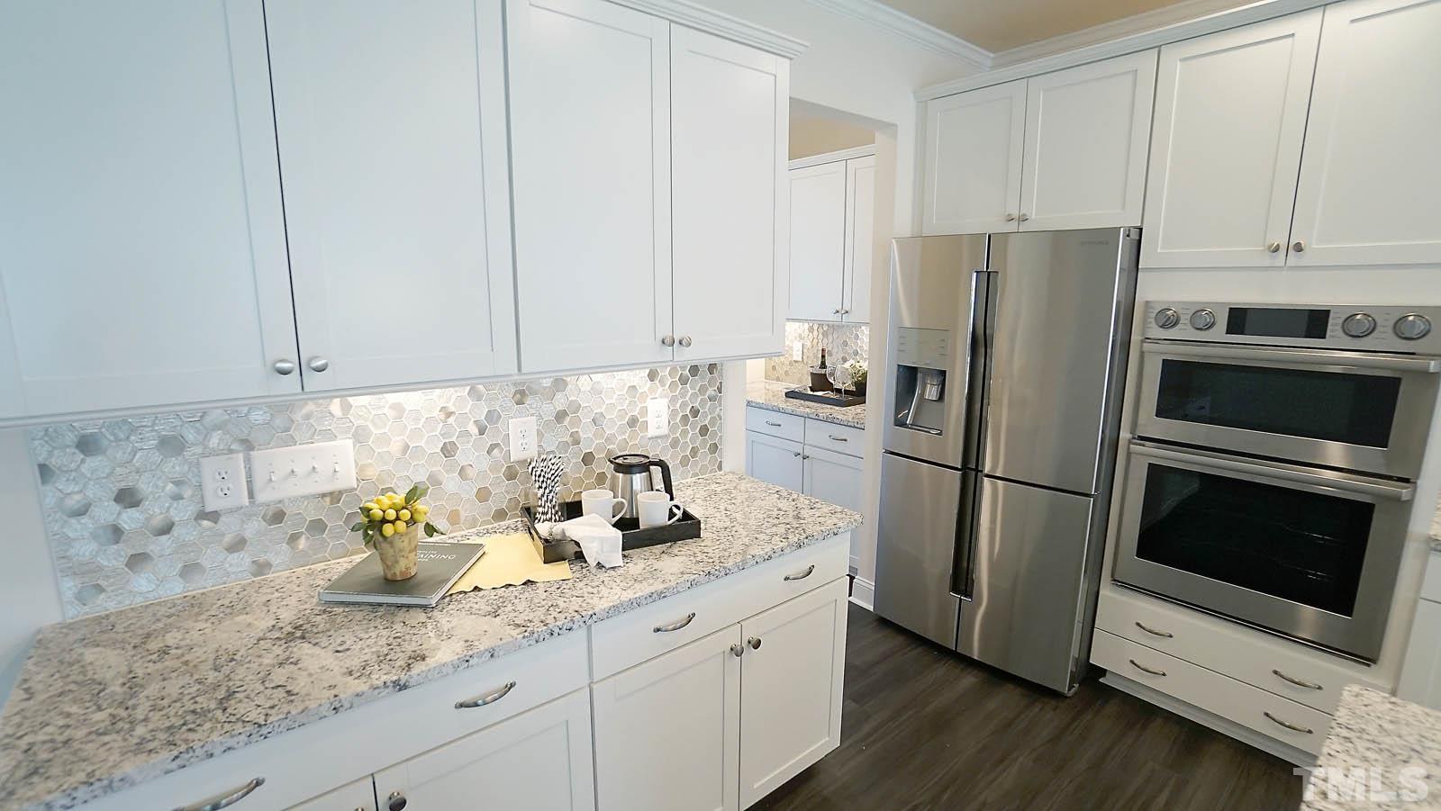 620 Trocha Drive Cary, NC 27513 - Photo 11 of 44 a kitchen with stainless steel appliances granite countertop a refrigerator sink and stove