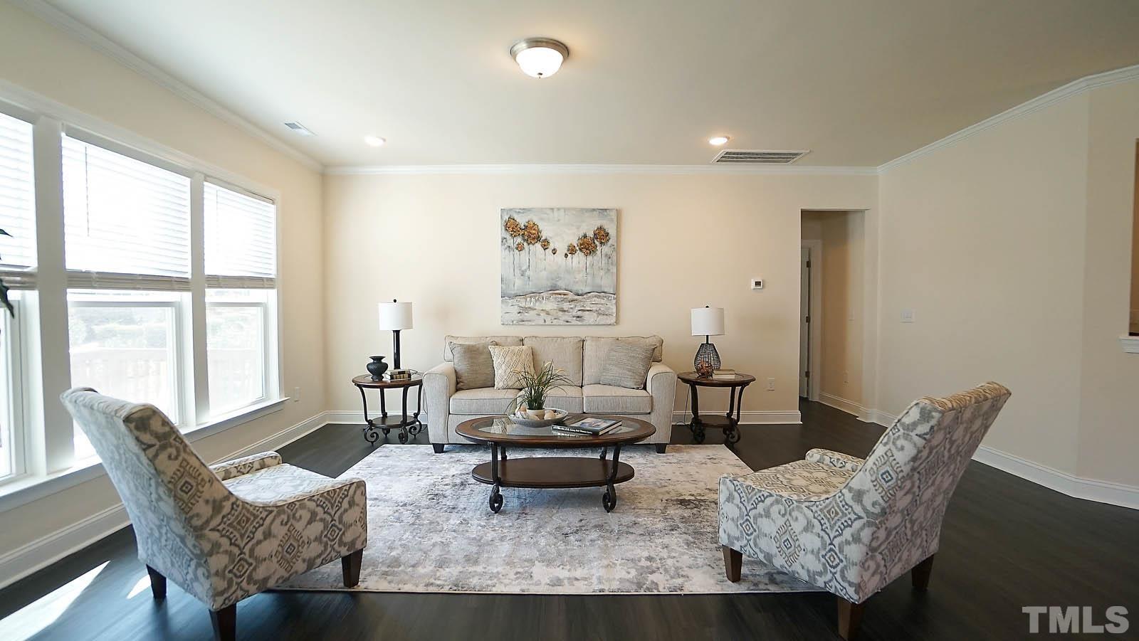 620 Trocha Drive Cary, NC 27513 - Photo 18 of 44 a living room with furniture and a large window