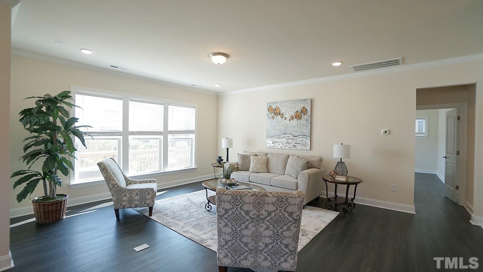 620 Trocha Drive Cary, NC 27513 - Photo 19 of 44 a living room with furniture and a large window
