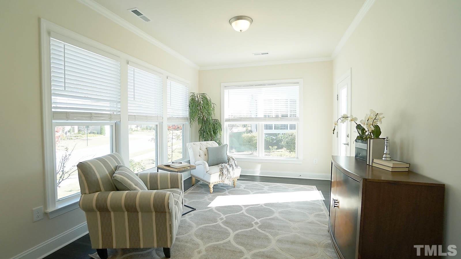 620 Trocha Drive Cary, NC 27513 - Photo 24 of 44 a living room with furniture and a potted plant