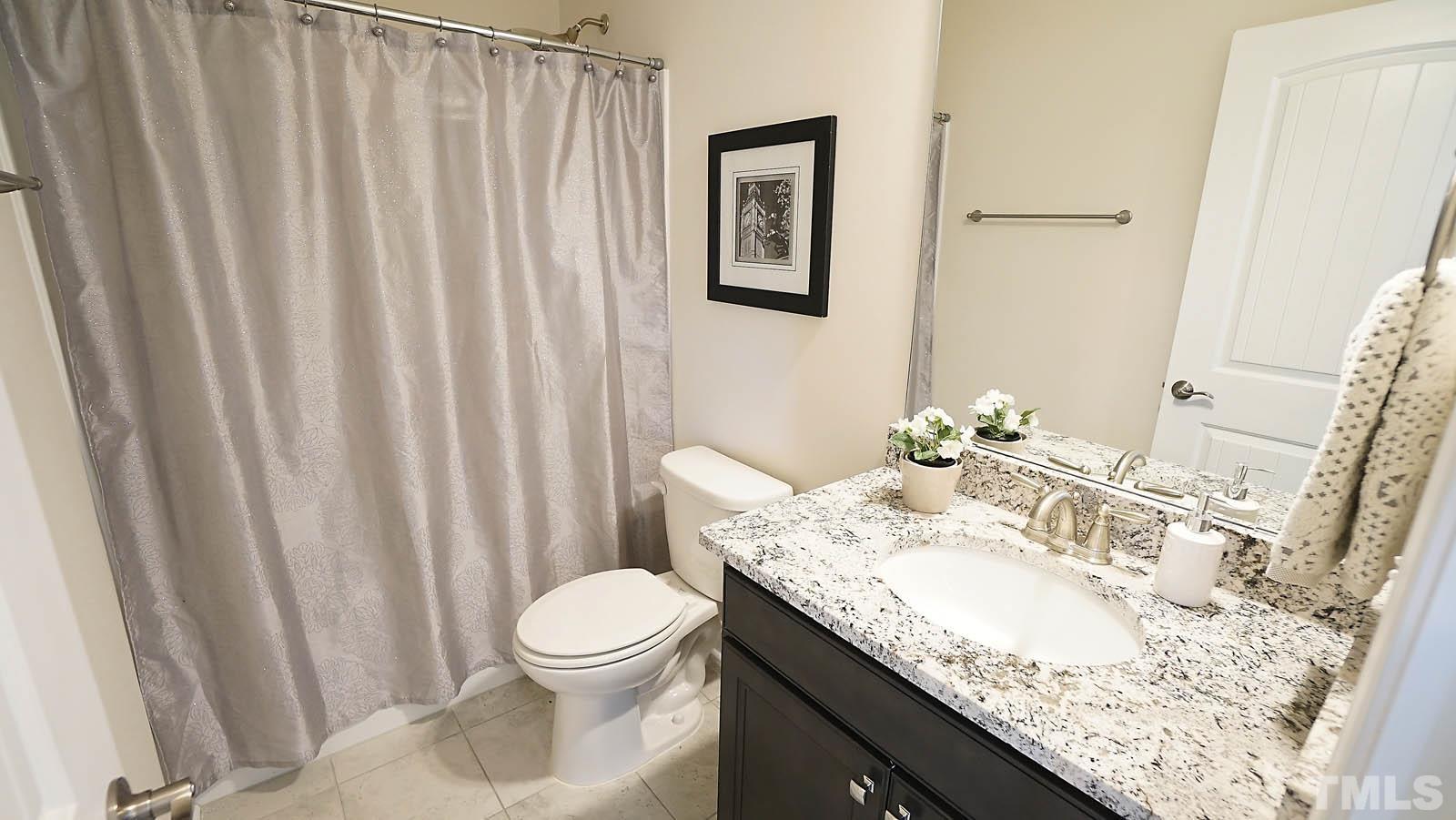 620 Trocha Drive Cary, NC 27513 - Photo 27 of 44 a bathroom with a granite countertop sink and a mirror