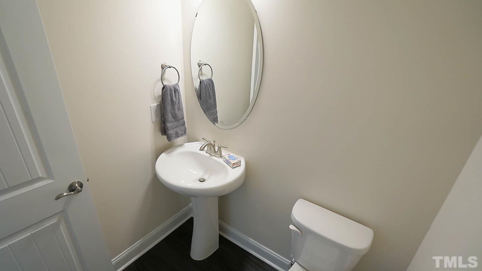 620 Trocha Drive Cary, NC 27513 - Photo 28 of 44 a bathroom with a toilet sink and mirror