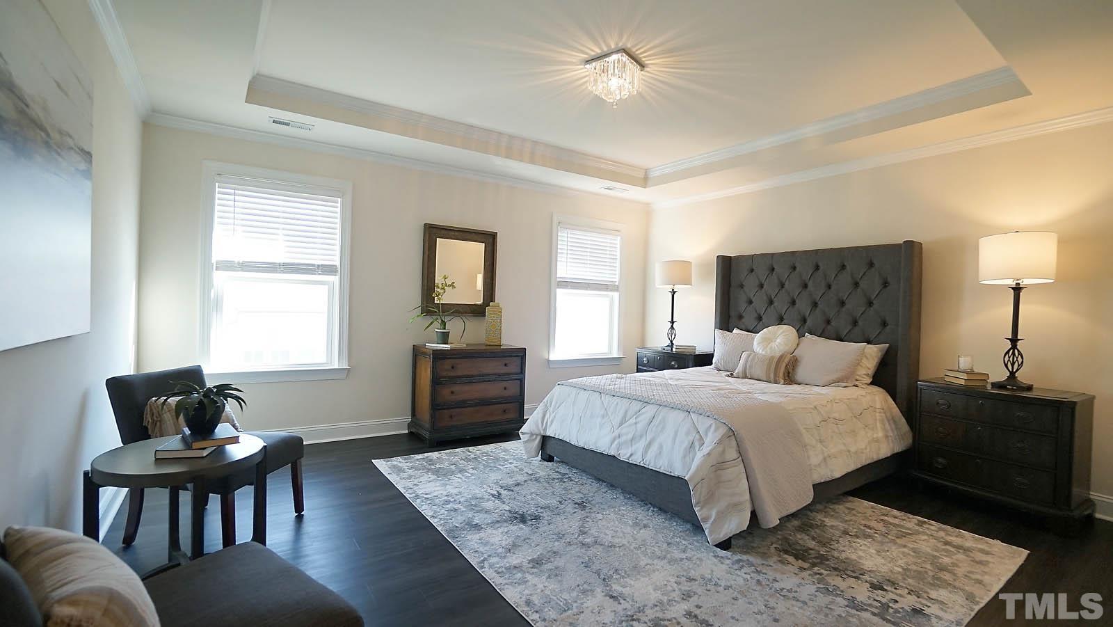 620 Trocha Drive Cary, NC 27513 - Photo 32 of 44 a bedroom with a bed and wooden floor