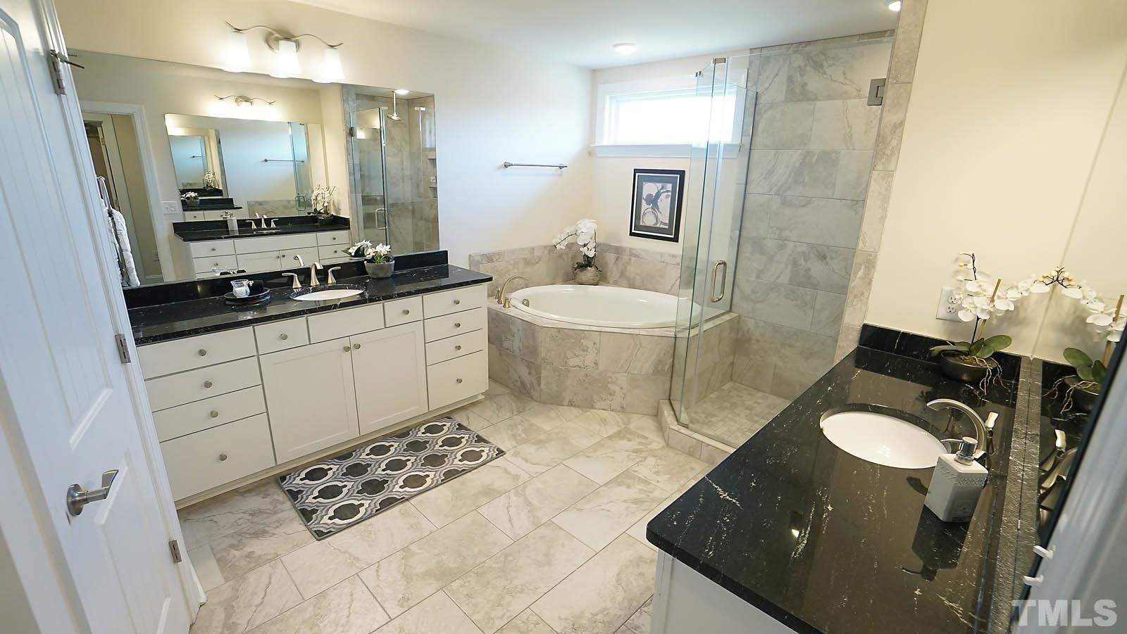 620 Trocha Drive Cary, NC 27513 - Photo 34 of 44 a bathroom with a sink a toilet a mirror and shower