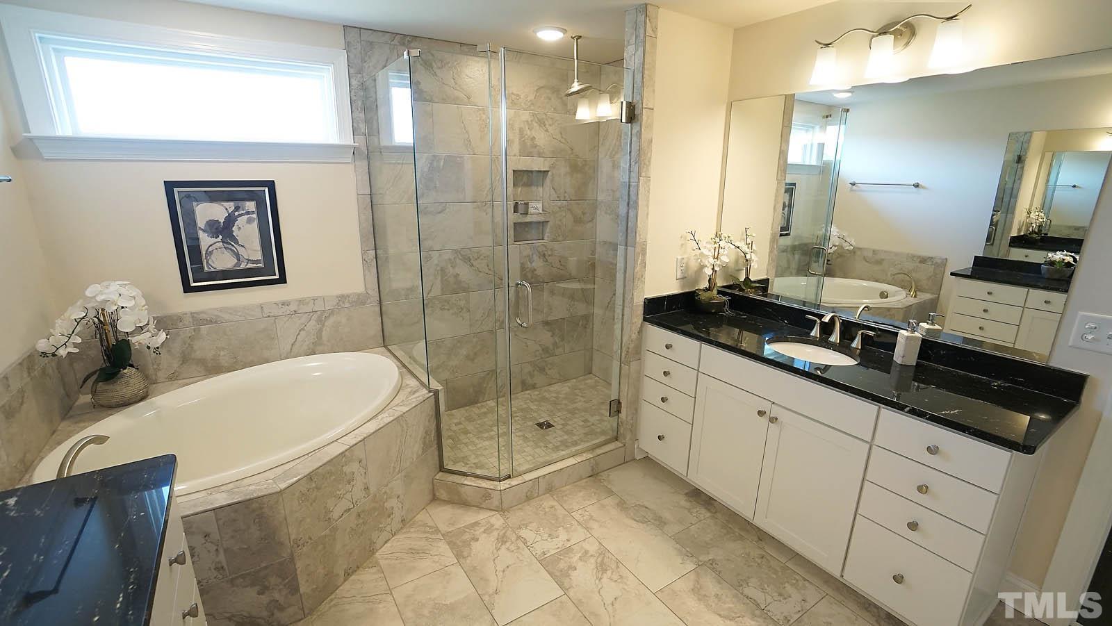 620 Trocha Drive Cary, NC 27513 - Photo 35 of 44 a bathroom with a granite countertop sink a toilet a mirror and shower
