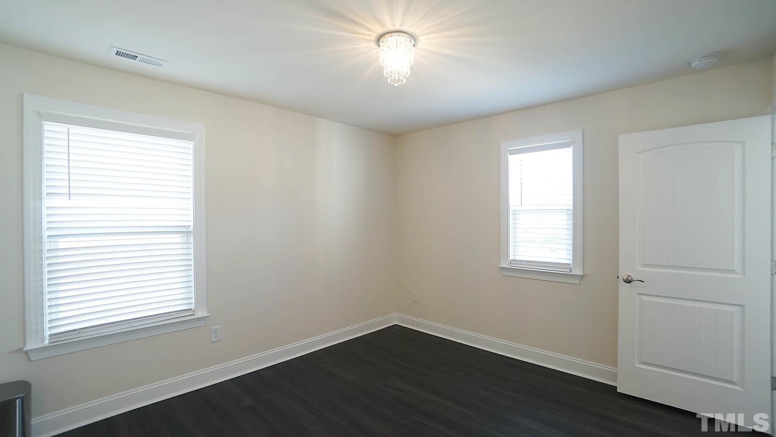 620 Trocha Drive Cary, NC 27513 - Photo 40 of 44 a view of an empty room with wooden floor and a window