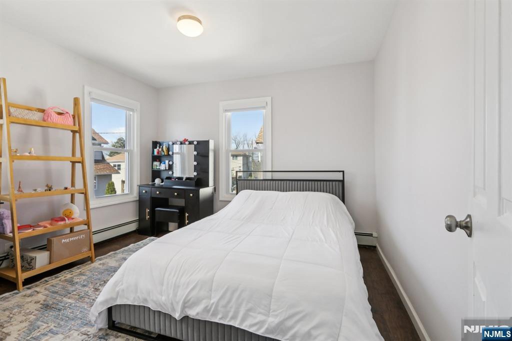 22 Treptow Street Little Ferry, NJ 07643 - Photo 22 of 44 a bed room with a bed and a chair