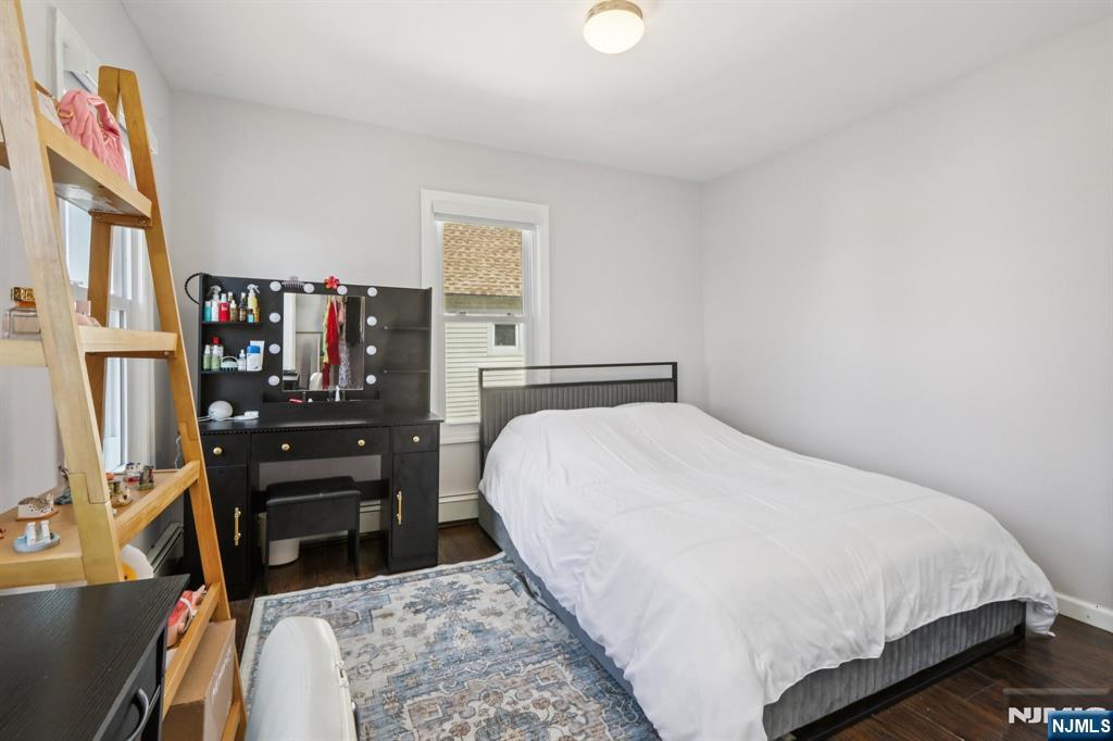 22 Treptow Street Little Ferry, NJ 07643 - Photo 23 of 44 a bedroom with a bed and a flat tv screen on dresser