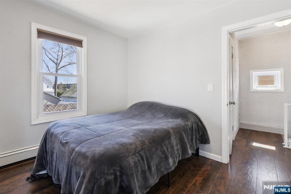 22 Treptow Street Little Ferry, NJ 07643 - Photo 27 of 44 a bedroom with a bed and wooden floor