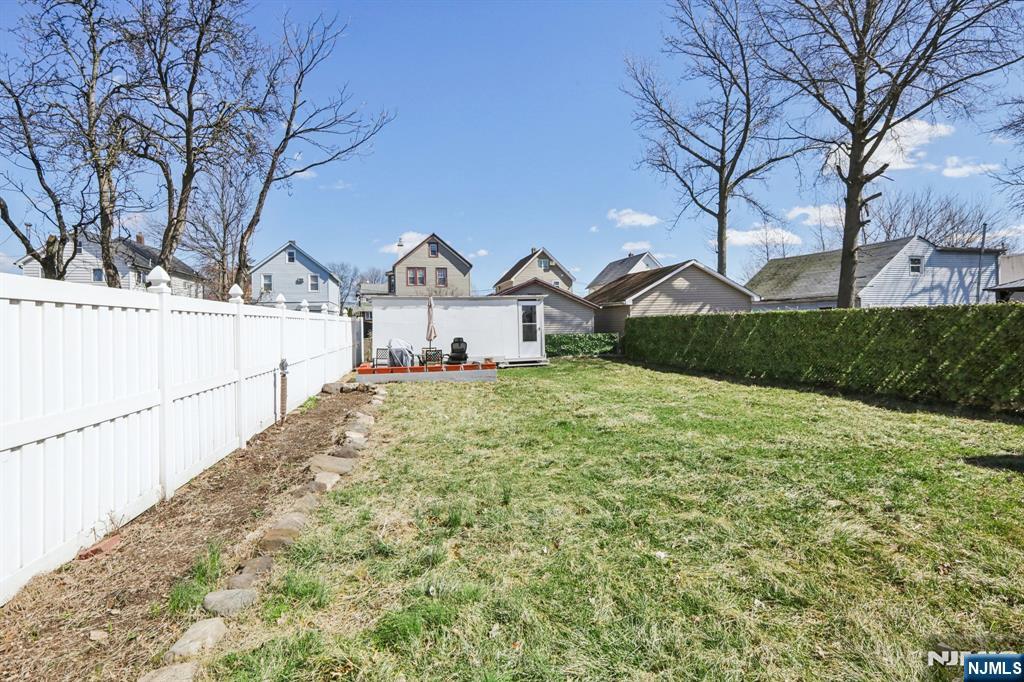 22 Treptow Street Little Ferry, NJ 07643 - Photo 38 of 44 a view of a large house with a big yard and large tree