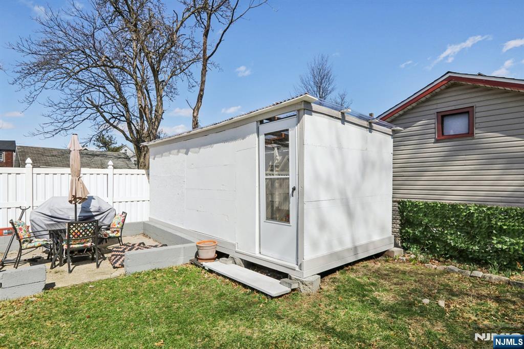 22 Treptow Street Little Ferry, NJ 07643 - Photo 40 of 44 a backyard of a house with table and chairs