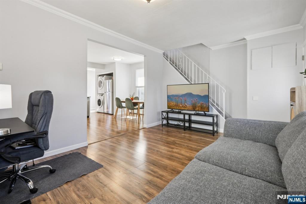 22 Treptow Street Little Ferry, NJ 07643 - Photo 8 of 44 a living room with furniture and a dining table with wooden floor