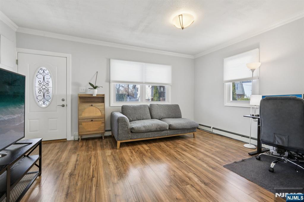 22 Treptow Street Little Ferry, NJ 07643 - Photo 9 of 44 a living room with furniture and a flat screen tv