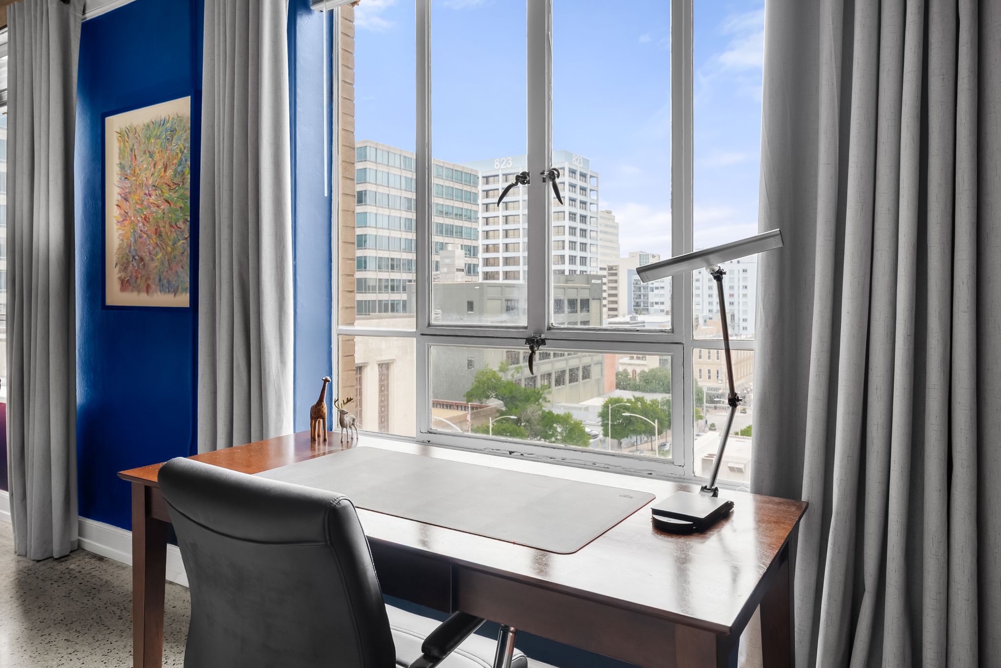 710 Colorado Street, Unit 6E Austin, TX 78701 - Photo 11 of 24 A well-lit home office features an expansive window with city views, perfect for productivity.