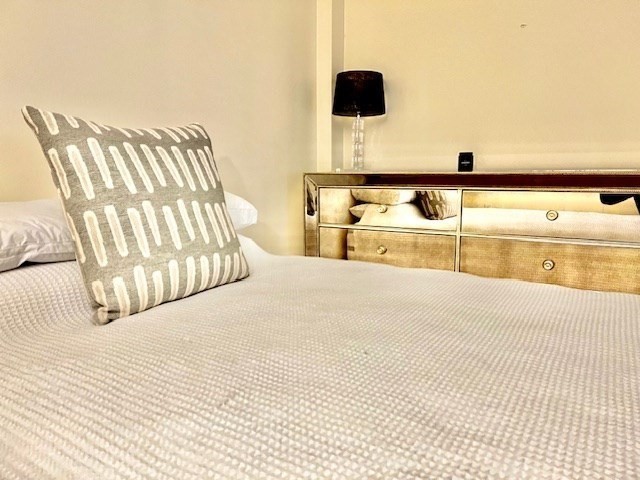 a bedroom with a bed and a large window