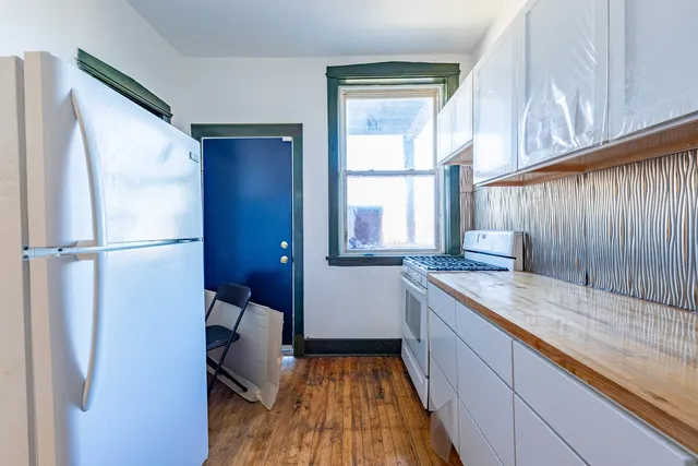 a bathroom with a granite countertop sink and a large mirror