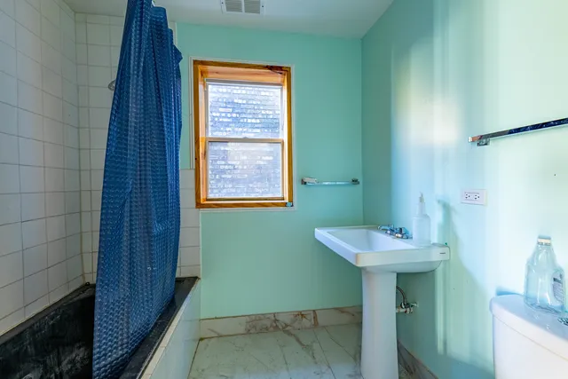 a bathroom with a sink a toilet and a mirror