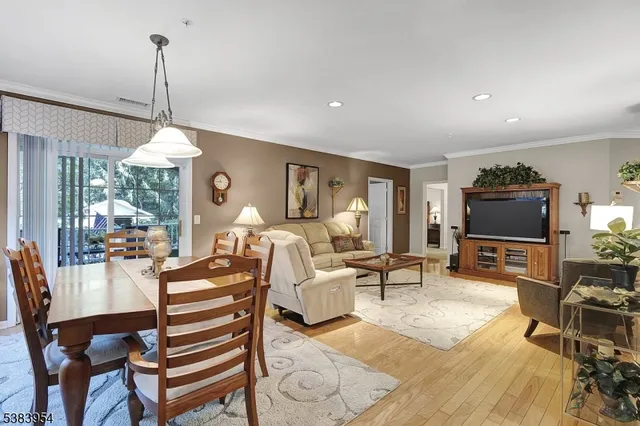 a living room with furniture a flat screen tv and a large window