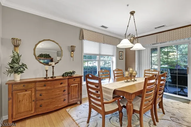 a dining room with furniture a chandelier and window