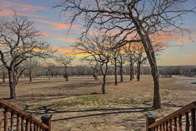 a view of a yard with wooden fence