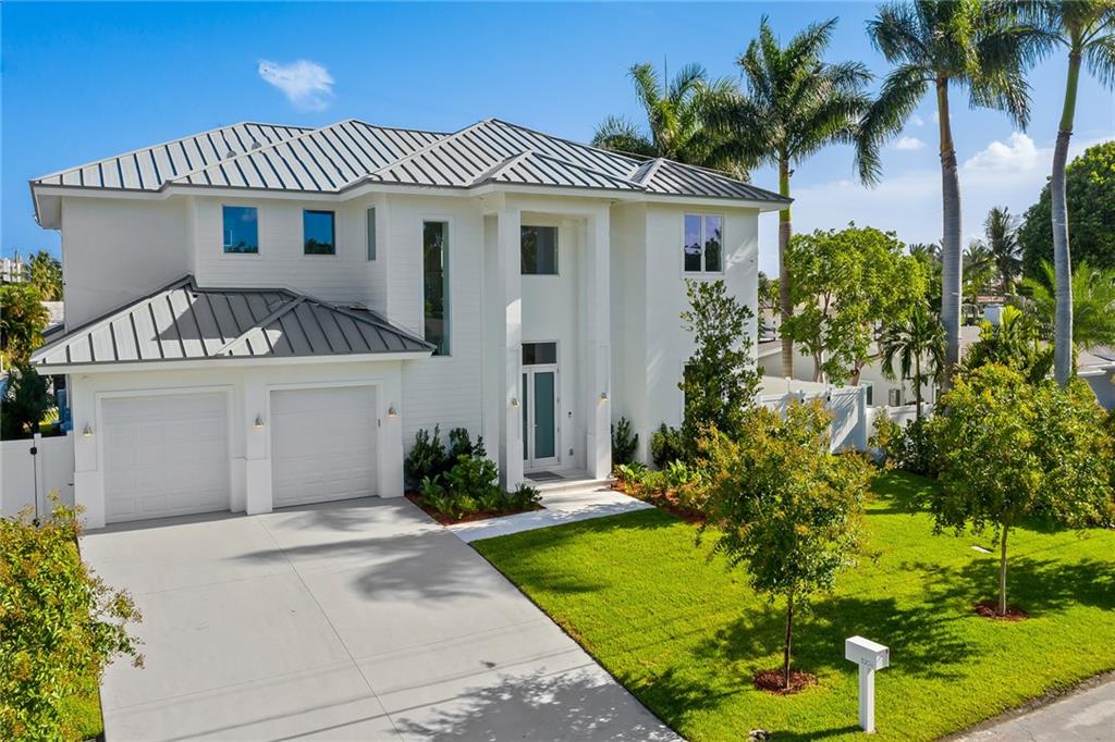 3204 Dover Road Pompano Beach, FL 33062 - Photo 8 of 73 a front view of a house with a garden