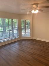 11792 Farrell Road Willis, TX 77378 - Photo 11 of 16 a view of empty room with wooden floor and fan
