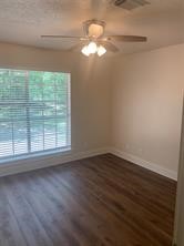 11792 Farrell Road Willis, TX 77378 - Photo 12 of 16 wooden floor in an empty room with a window