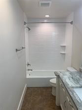 11792 Farrell Road Willis, TX 77378 - Photo 14 of 16 a bathroom with a granite countertop sink toilet and shower