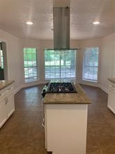 11792 Farrell Road Willis, TX 77378 - Photo 5 of 16 a kitchen with granite countertop a stove and a sink