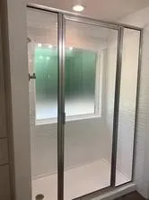 a bathroom with a glass shower door